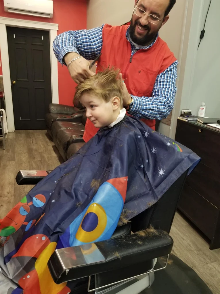 Nabil cutting a child's hair